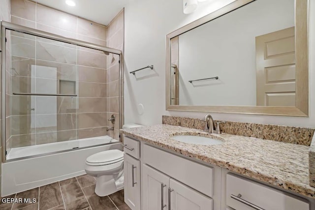 full bath with toilet, shower / bath combination with glass door, vanity, and wood tiled floor