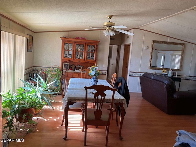 770 Eagles Den Ln, El Paso, TX 79927 - dining room featuring ceiling fan, vaulted ceiling, a textured ceiling, and wood finished floors