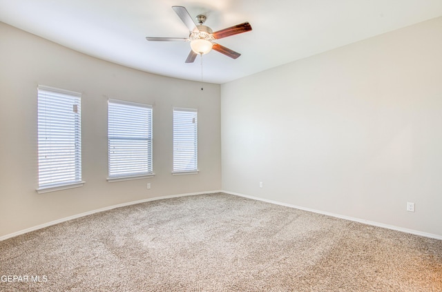 carpeted empty room featuring a ceiling fan