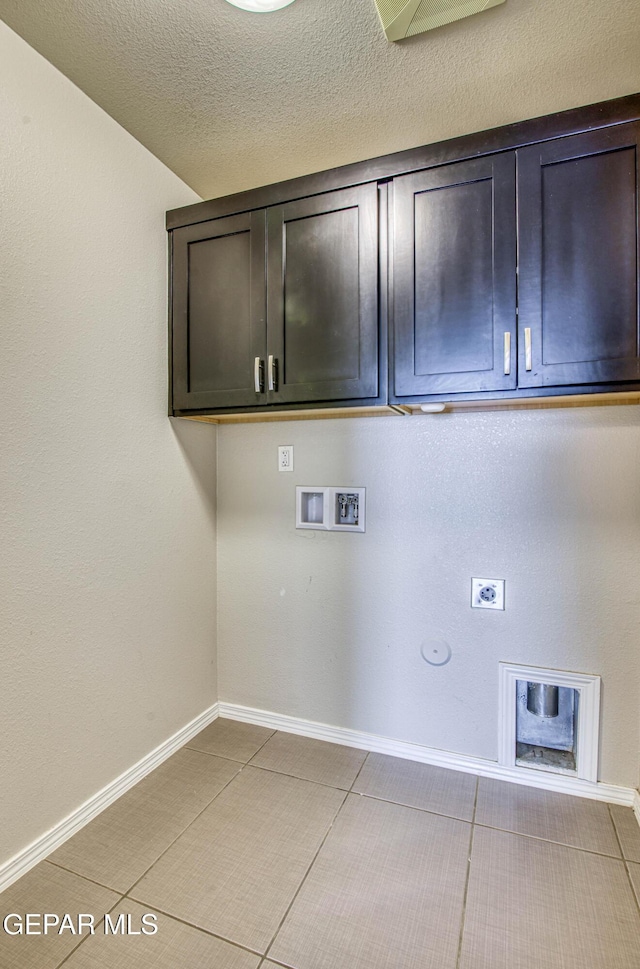 laundry area with cabinet space, baseboards, hookup for a gas dryer, a textured ceiling, and washer hookup