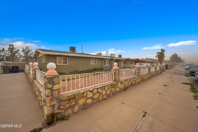 ranch-style house featuring brick siding and fence