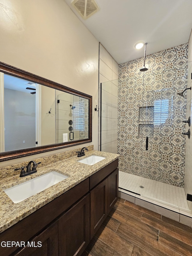 bathroom featuring a walk in shower, a sink, and visible vents