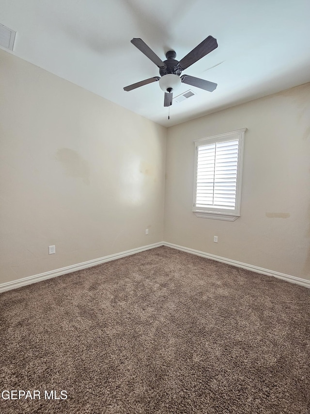 unfurnished room featuring carpet floors, baseboards, and visible vents