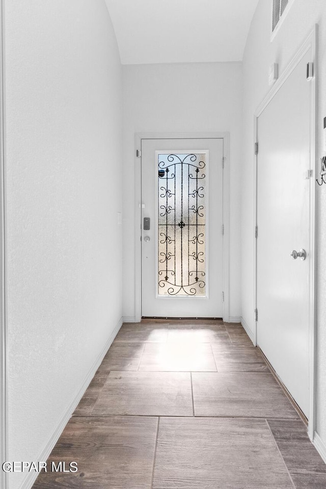 entrance foyer featuring light wood finished floors, visible vents, and baseboards