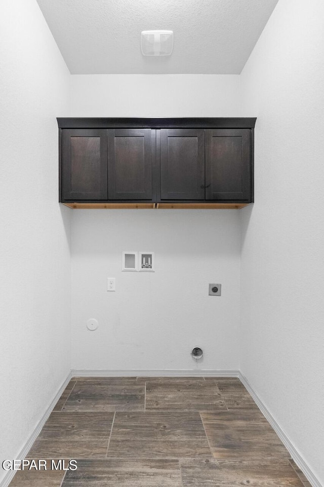 laundry area with cabinet space, gas dryer hookup, dark wood-style flooring, hookup for a washing machine, and hookup for an electric dryer