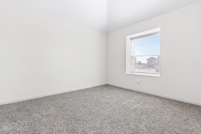 empty room with carpet and baseboards