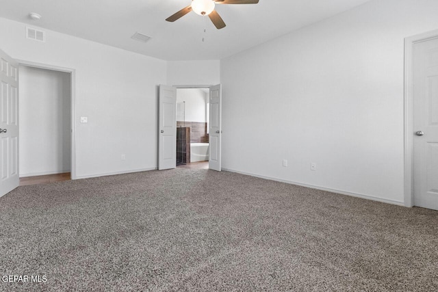 unfurnished bedroom featuring carpet floors, a ceiling fan, visible vents, and baseboards