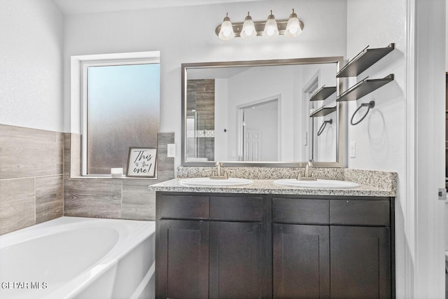 full bathroom featuring a garden tub, a sink, and double vanity