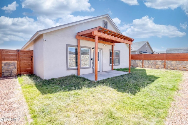 back of property with a yard, a patio area, a fenced backyard, and stucco siding