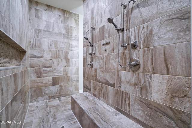 full bath with a tile shower