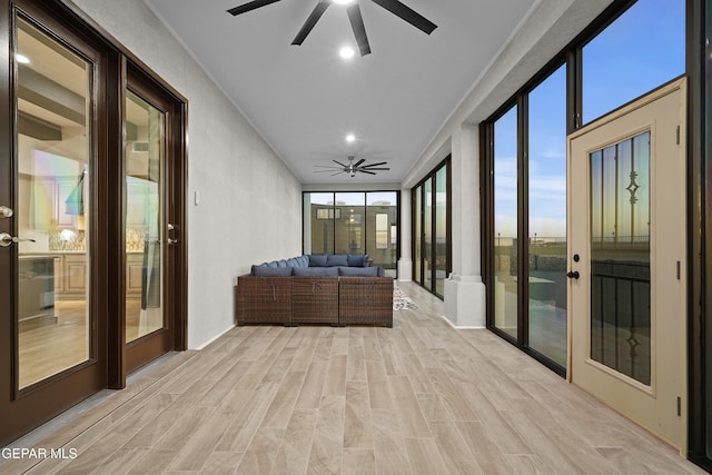 sunroom / solarium featuring french doors and ceiling fan