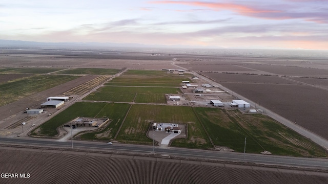 aerial view at dusk featuring a rural view