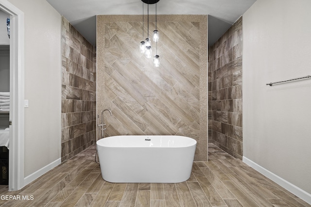 full bath featuring a freestanding tub, walk in shower, tile walls, and wood finish floors