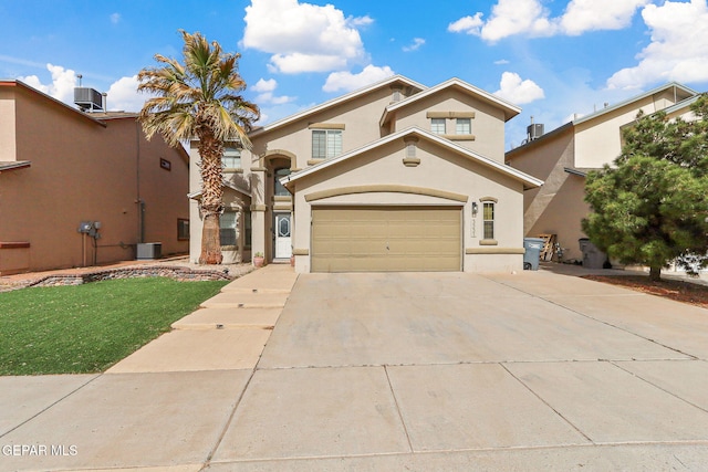 mediterranean / spanish home with a garage, central AC, driveway, and stucco siding