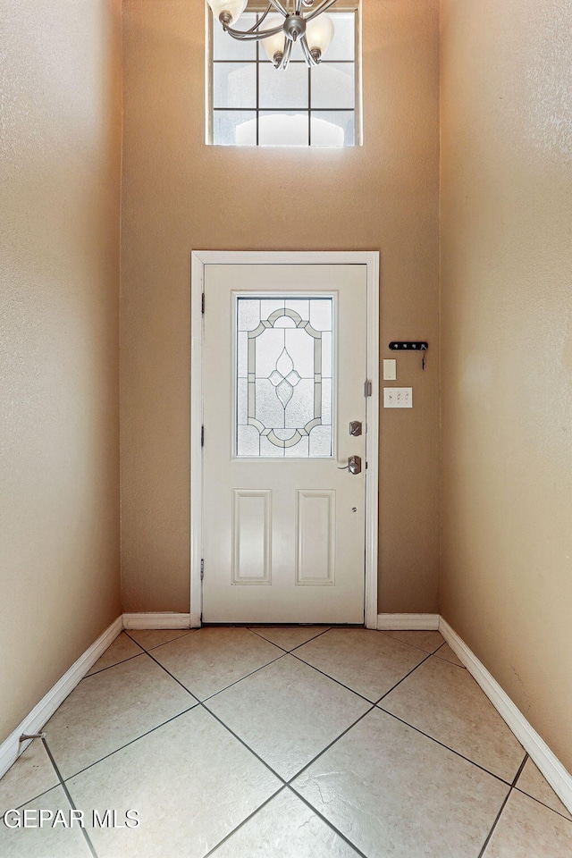 3537 Tierra Bahia Dr, El Paso, TX 79938 - foyer entrance with a chandelier, tile patterned flooring, and baseboards