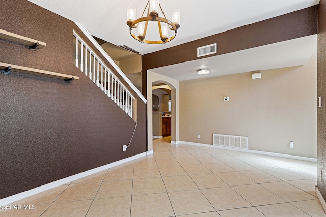3537 Tierra Bahia Dr, El Paso, TX 79938 - interior space featuring tile patterned flooring, visible vents, arched walkways, and a chandelier