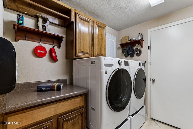 3537 Tierra Bahia Dr, El Paso, TX 79938 - washroom with a textured ceiling, light tile patterned floors, washing machine and clothes dryer, and cabinet space
