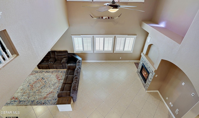 3537 Tierra Bahia Dr, El Paso, TX 79938 - living area with a fireplace, ceiling fan, baseboards, and tile patterned floors