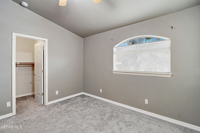 3537 Tierra Bahia Dr, El Paso, TX 79938 - unfurnished bedroom with carpet flooring, a ceiling fan, baseboards, vaulted ceiling, and a spacious closet