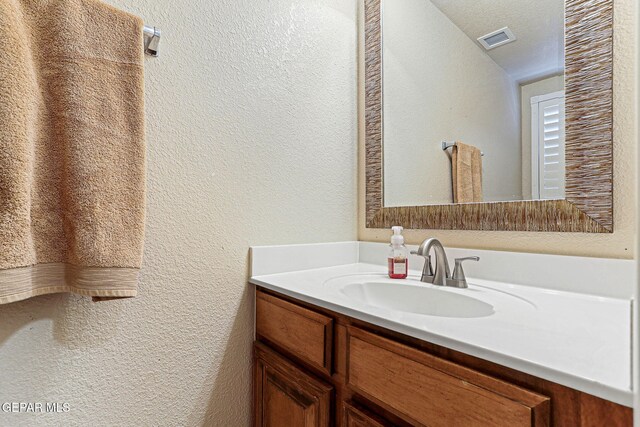 3537 Tierra Bahia Dr, El Paso, TX 79938 - bathroom with a textured ceiling, a textured wall, vanity, and visible vents