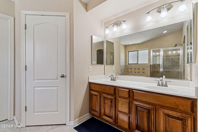 3537 Tierra Bahia Dr, El Paso, TX 79938 - full bathroom featuring double vanity, a shower stall, a sink, and tile patterned floors