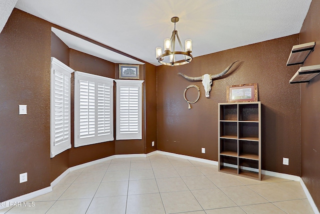 3537 Tierra Bahia Dr, El Paso, TX 79938 - tiled empty room with baseboards and an inviting chandelier