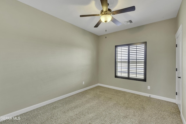 spare room with carpet flooring, visible vents, ceiling fan, and baseboards