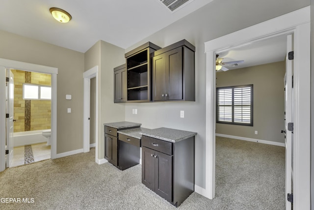 kitchen featuring light carpet, plenty of natural light, visible vents, and open shelves