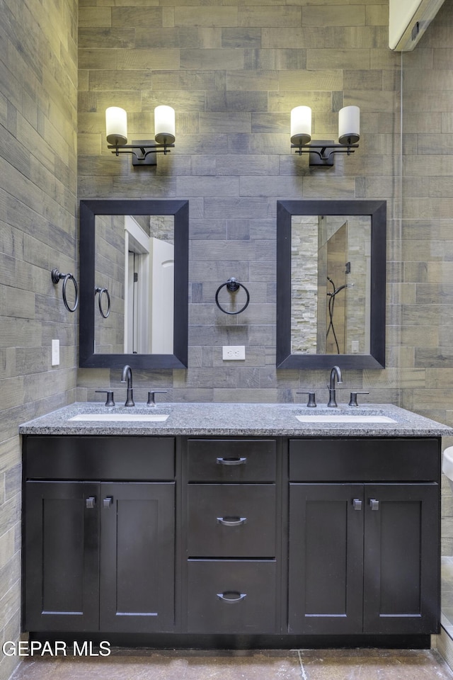 bathroom featuring double vanity, a sink, and decorative backsplash