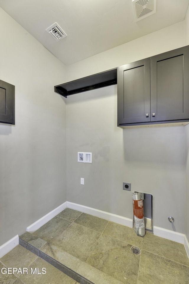 clothes washing area featuring baseboards, cabinet space, visible vents, and electric dryer hookup