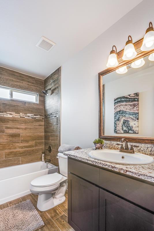 14291 Armando Silva Dr, El Paso, TX 79938 - bathroom featuring wood finish floors, visible vents, shower / bathing tub combination, toilet, and vanity