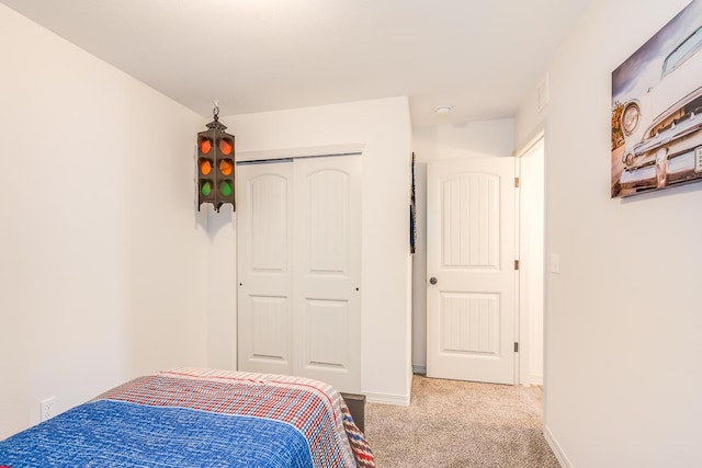 14291 Armando Silva Dr, El Paso, TX 79938 - bedroom with light carpet, baseboards, visible vents, and a closet