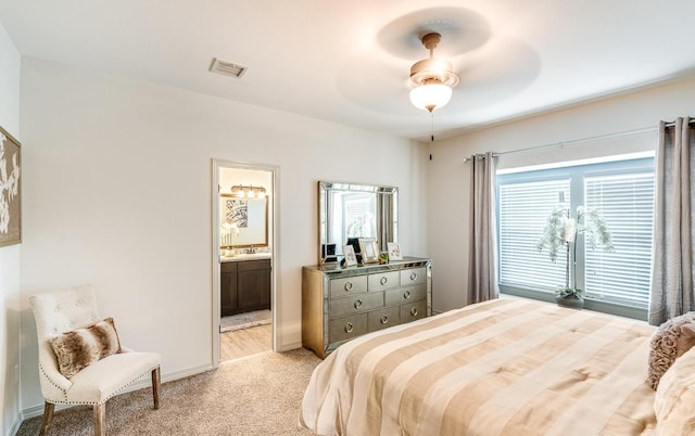 14291 Armando Silva Dr, El Paso, TX 79938 - bedroom with ensuite bathroom, light colored carpet, a ceiling fan, baseboards, and visible vents