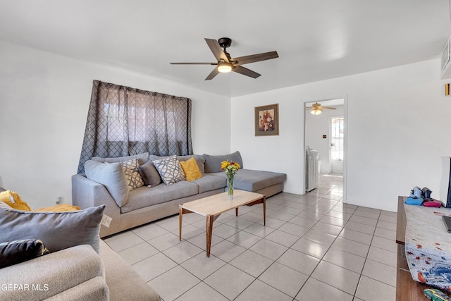 living room featuring light tile patterned floors, ceiling fan, and baseboards