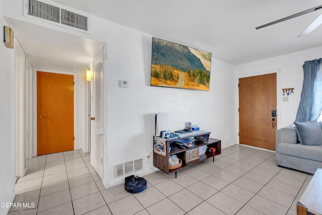 living area featuring visible vents and light tile patterned flooring