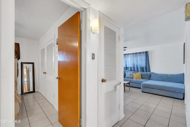 hall with light tile patterned floors