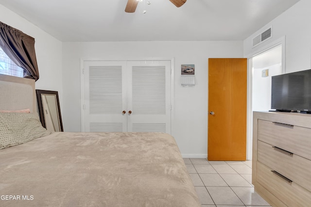 unfurnished bedroom with a ceiling fan, a closet, light tile patterned flooring, and visible vents