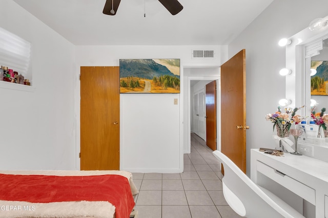 bedroom with ceiling fan, visible vents, and light tile patterned flooring