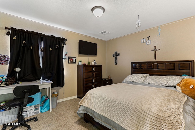 carpeted bedroom with visible vents and baseboards