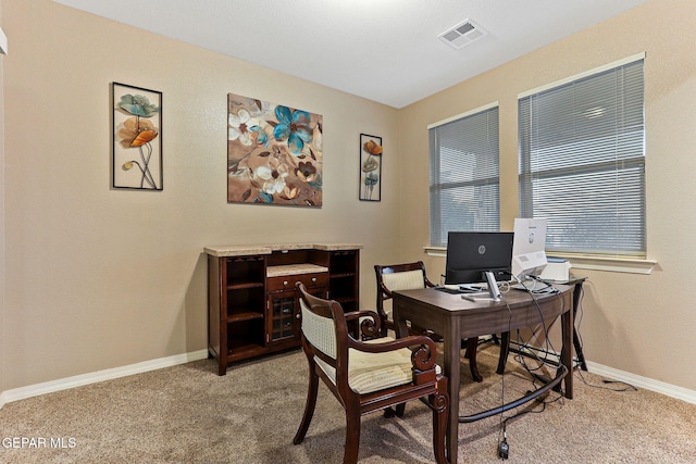 office featuring carpet, visible vents, and baseboards