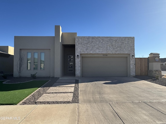 view of front of property with a garage, driveway, and stucco siding