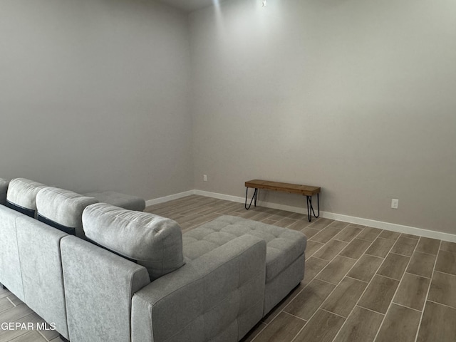 living area featuring baseboards and wood tiled floor