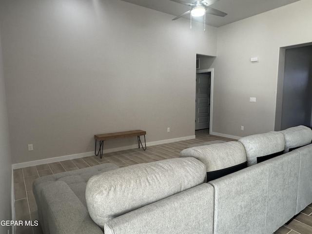 living room featuring ceiling fan, wood finish floors, and baseboards