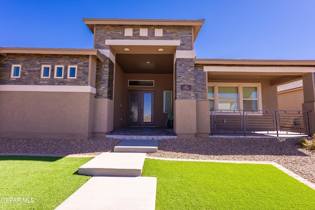 exterior space featuring a lawn, stone siding, french doors, a porch, and stucco siding