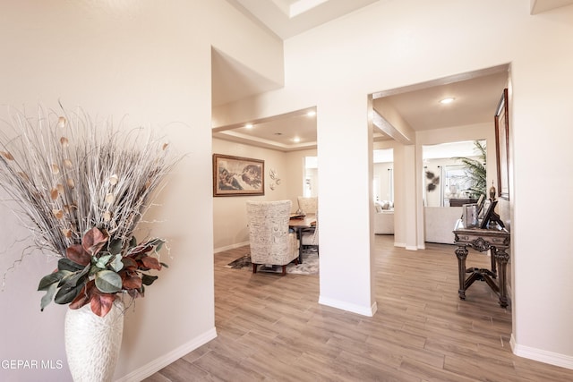 hallway with light wood-style flooring and baseboards