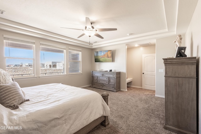 bedroom featuring carpet floors, visible vents, baseboards, and a tray ceiling