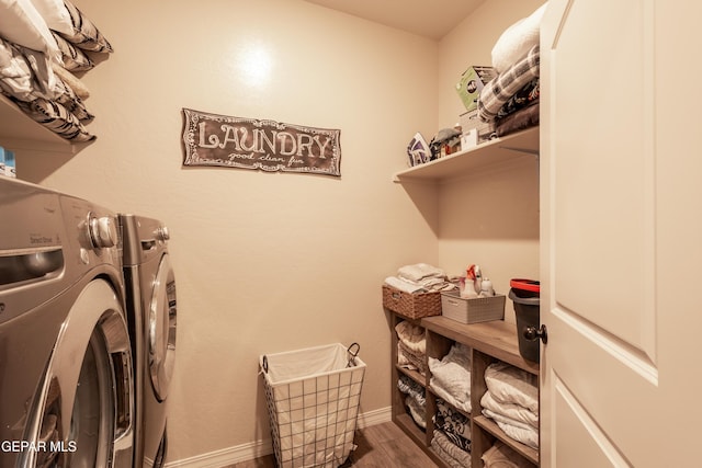 clothes washing area featuring laundry area, independent washer and dryer, wood finished floors, and baseboards