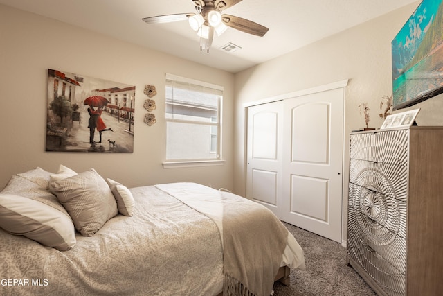 carpeted bedroom featuring a closet, visible vents, and ceiling fan