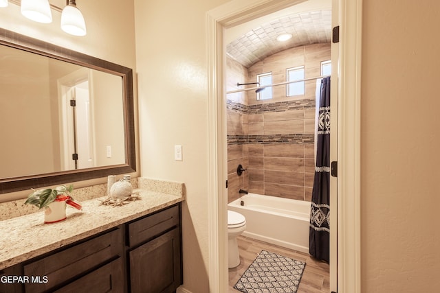 full bathroom with shower / tub combo with curtain, vanity, toilet, and wood finished floors