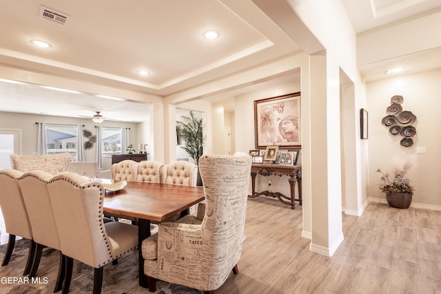 dining room with recessed lighting, visible vents, baseboards, light wood-type flooring, and a tray ceiling